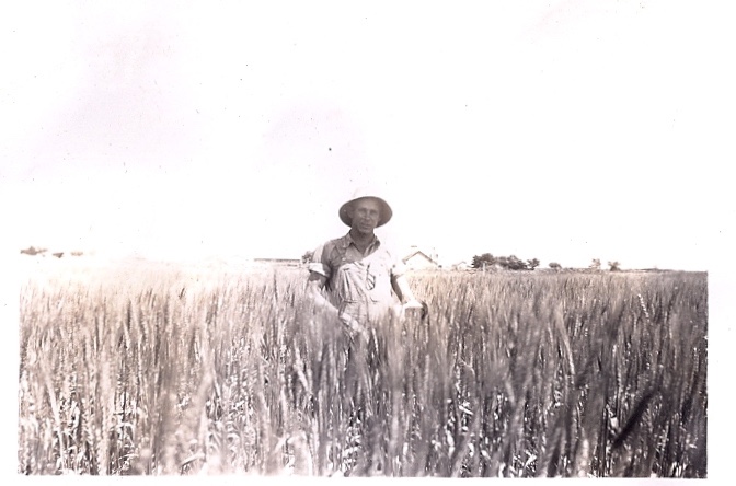 1944-Albert-our farm-behind him.jpg